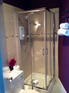 a shower with a glass door in a bathroom at Yacht Bay View in Morecambe