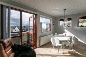 a living room with a table and a couch at FaroeGuide seaview villa and apartment in Tórshavn