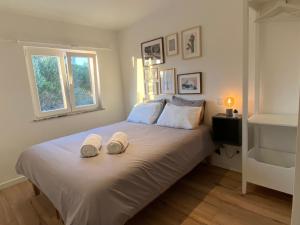 a bedroom with a bed with two towels on it at Your Home @ Benagil in Lagoa +69 photos