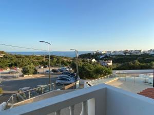 a balcony with a view of a parking lot and the ocean at Your Home @ Benagil in Lagoa