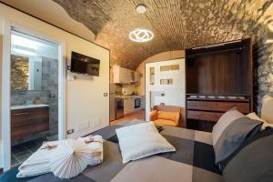a bedroom with a bed with an umbrella on it at Vicolo72 in Calitri