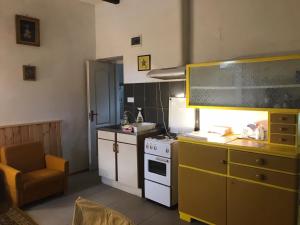 a kitchen with a sink and a stove top oven at Balogh vendégház II in Szeged