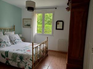 a bedroom with a bed and a window at Marie in Mignaloux-Beauvoir