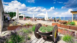 a restaurant with two large wheel planters on the beach at Winnica Nawrot in Mechelinki +9 photos