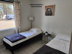 a bedroom with a bed and a window at Camping Lappeenranta in Lappeenranta