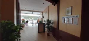 a hallway with potted plants in a building at Miramar Palace - Planeta Apartamenty 614A, 614S in Sunny Beach