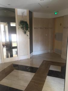 an empty room with a lobby with a plant on the wall at Iago lodge azur, 5 minutes à pied de la plage in Fréjus +11 photos