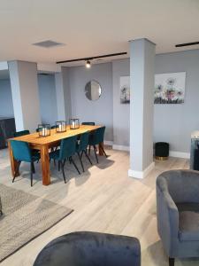 a conference room with a wooden table and chairs at 1-on-Albert Studio Apartments in Cape Town