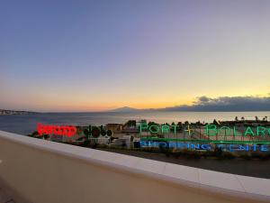 a sign for a train station with the sunset in the background at Lumarooms B&B in Reggio Calabria