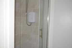 a shower with a soap dispenser in a bathroom at Kensington Guest House Liverpool in Liverpool