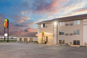 a hotel with a parking lot in front of it at Super 8 by Wyndham Watertown in Watertown