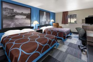 a hotel room with two beds and a tv at Super 8 by Wyndham Spokane Valley in Spokane Valley +36 photos