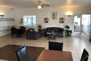 a living room with couches and a table and chairs at Super 8 by Wyndham Price in Price
