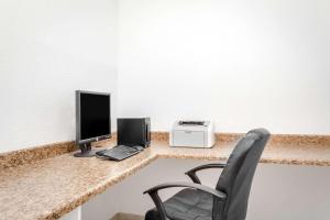 a desk with a computer and a monitor on it at Super 8 by Wyndham Price in Price