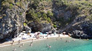 a group of people in the water at a beach at B&B Margherita in Marina di Camerota