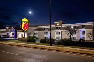 a sign in front of a hotel at night at Super 8 by Wyndham Wichita East in Wichita