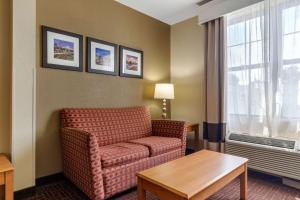 a living room with a couch and a table at Comfort Suites Hanes Mall in Winston-Salem