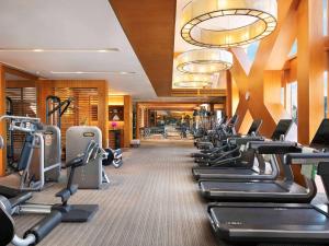 a gym with a row of tread machines at Fairmont Beijing in Beijing