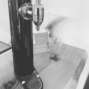 a black blender sitting on top of a wooden table at KAI Ichinomiya in Ichinomiya