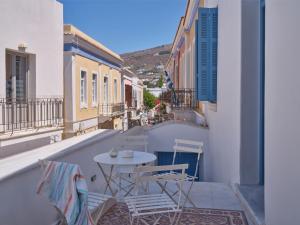 a patio with a table and chairs on a balcony at Retreat Paros - The Loft Apartment in Parikia