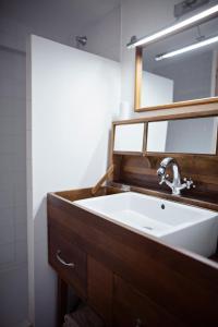 a bathroom with a sink and a mirror at XVIII Century Gem With Magnificent Views Of The Harbour with a private garage in Saint-Martin-de-Ré