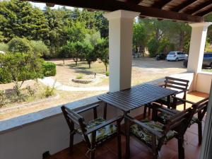 a black table and chairs on a porch at Lemontree Apartments in Kassiopi