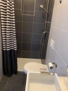 a bathroom with a toilet and a sink and a shower at BEACH SEA VIEW APPARTMENT in Podgora
