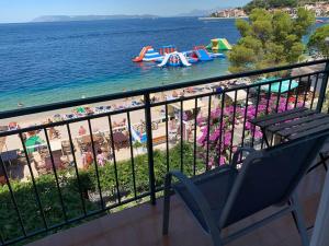 a balcony with a view of the beach and water at BEACH SEA VIEW APPARTMENT in Podgora