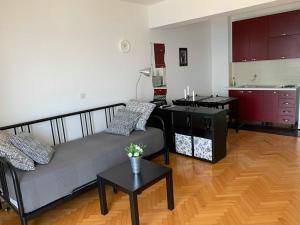 a living room with a couch and a kitchen at BEACH SEA VIEW APPARTMENT in Podgora