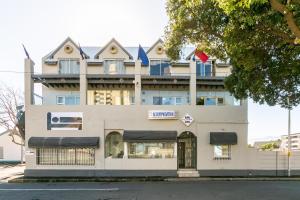 a building on the corner of a street at Bedrock- Executive Self Catering Room in Cape Town