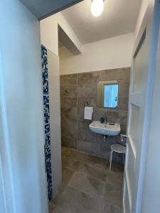 a bathroom with a sink and a mirror at Two Palms Apartment in Sutomore