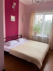 a bedroom with a bed and a window at Hotel Kardinal in Vinnytsya
