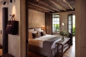 a bedroom with a large bed and a window at La Ferme Saint Simeon Spa - Relais & Chateaux in Honfleur