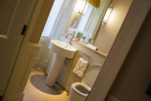 a small bathroom with a sink and a toilet at Houndgate Townhouse in Darlington