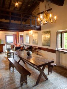 a living room with a wooden table and a couch at Riserva Privata San Settimio in Arcevia