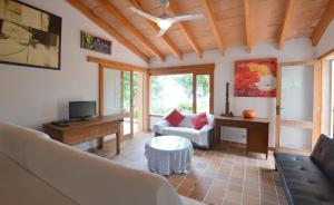 a living room with a couch and a table at Alconasser 3 - Amazing Seaviews between Deia & Soller in Sóller