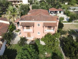 an aerial view of a large pink house at Elena's Apartments Corfu in Ipsos