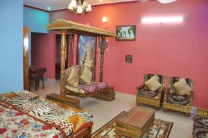 a room with a bed and chairs in it at Yelagiri EGV Residency in Yelagiri