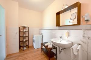 a bathroom with a sink and a mirror at Stadtapartments Forchheim in Forchheim