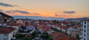 a view of a city at sunset with buildings at Svir Skyline Apartment No 39 in Ohrid