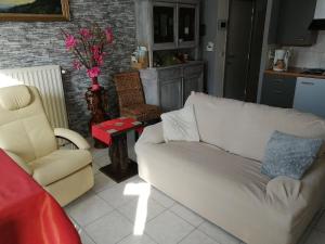 a living room with a couch and a chair at Vakantie Aan Zee in De Panne