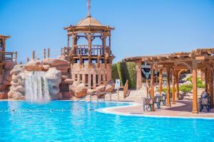 a water park with a waterfall and a water slide at Charmillion Sea Life Resort in Sharm El Sheikh