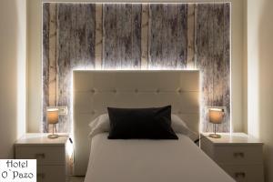 a bedroom with a white bed with two night stands at Hotel O'Pazo in Vigo
