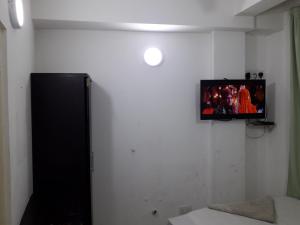 a tv on a wall in a room at REYALI GUEST HOUSE in Male City