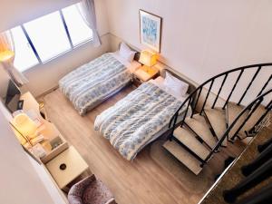 Un pat sau paturi într-o cameră la Palcall Tsumagoi Resort Ski & Hotel