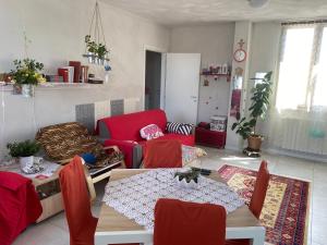 a living room with a table and red chairs at Camera Monica in Peschiera del Garda