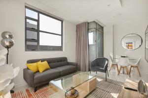 a living room with a couch and a table at The Median Apartments in Johannesburg