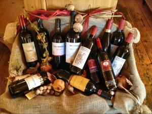 a bunch of bottles of wine sitting on a bag at Hotel Zur Kirche in Magrè allʼ Adige