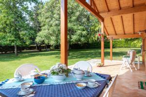 a table with a blue table cloth on a patio at Villa degli Ulivi in Lempa