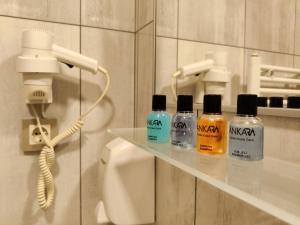 a bathroom with four bottles on a shelf next to a phone at CONCEPT HoUSE in Ankara +27 photos